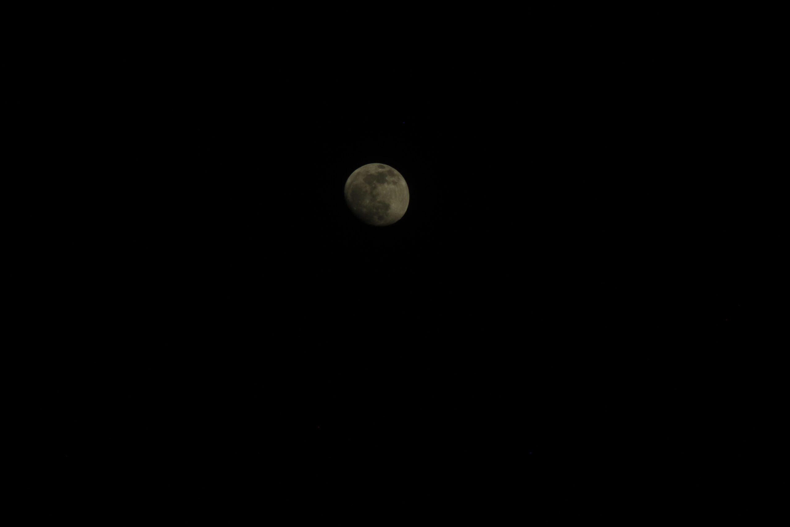 Underexposed photograph of the Moon showing insufficient recorded light
