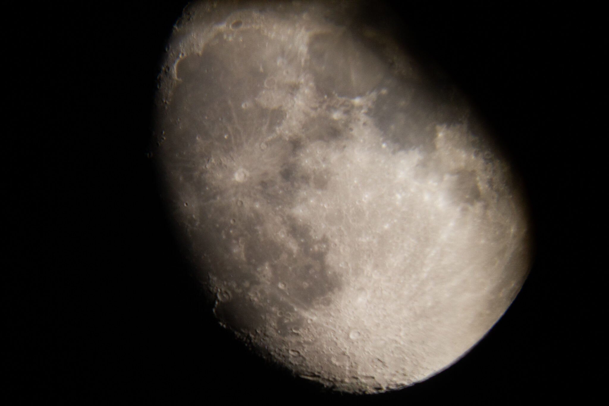 Moon near the terminator showing craters and surface relief created by low-angle sunlight.